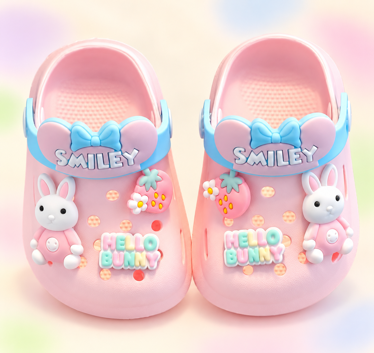 Pink and blue bunny character clogs on a branded studio background